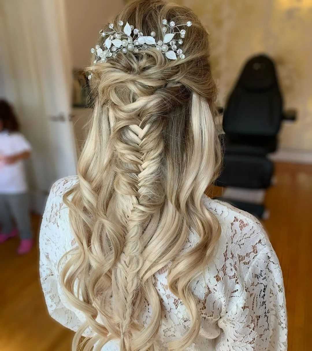Elegant braided hairstyle with decorative hairpiece, styled in long, blonde curls.